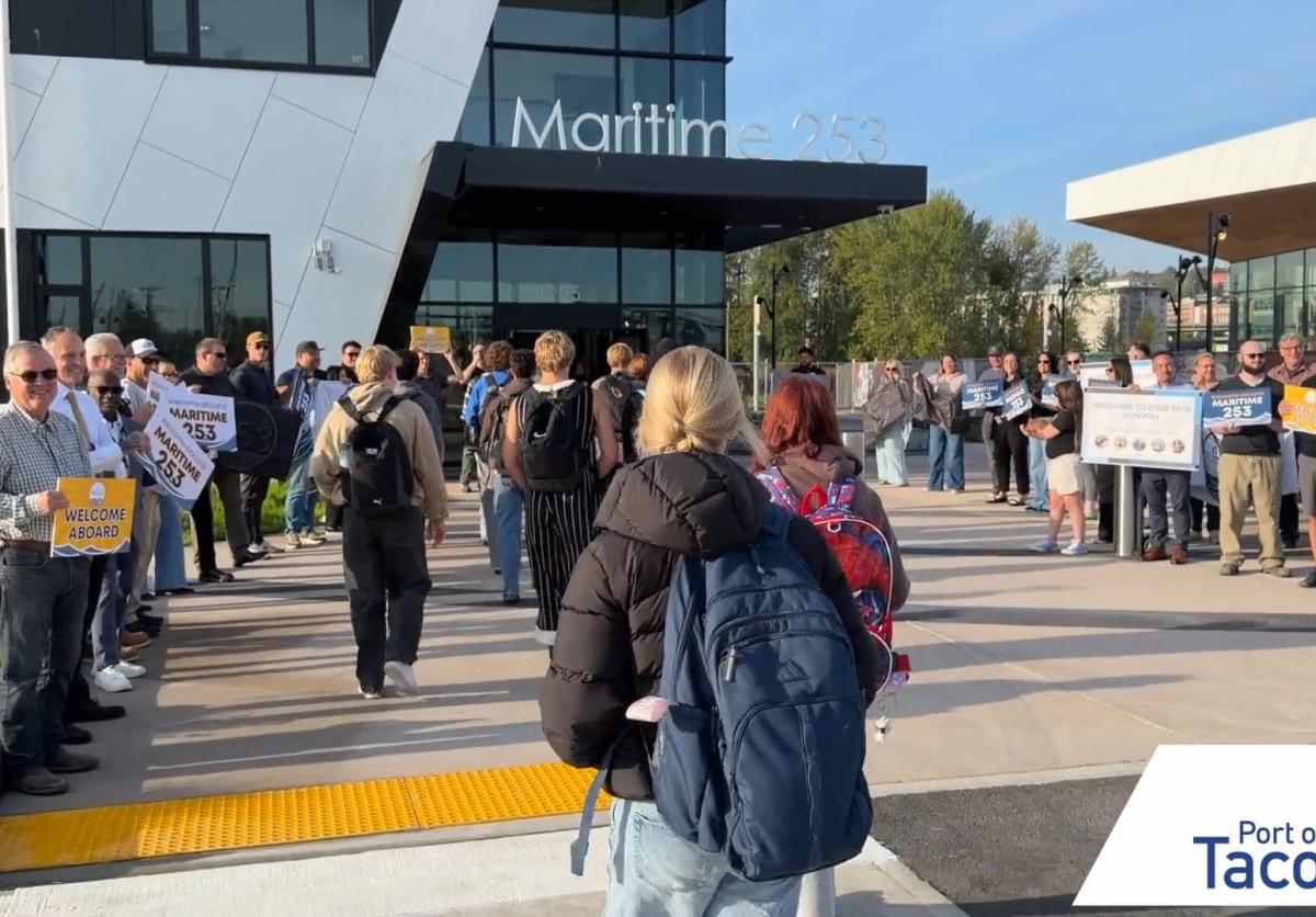 Thumbnail of students walking into the Maritime|253 skills center while a group of adults cheer and hold signs.